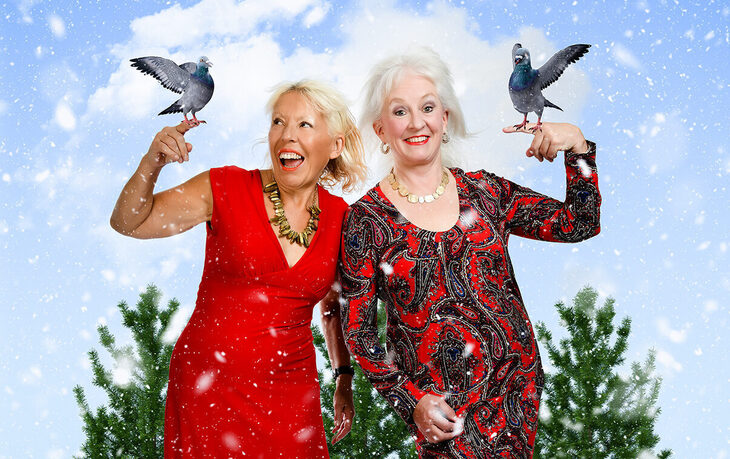 Two women with dove on their hands