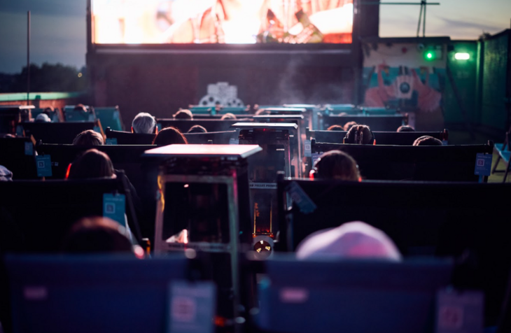 People watching a film outside
