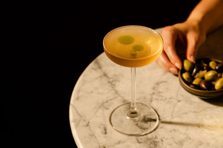 A cocktail and olives