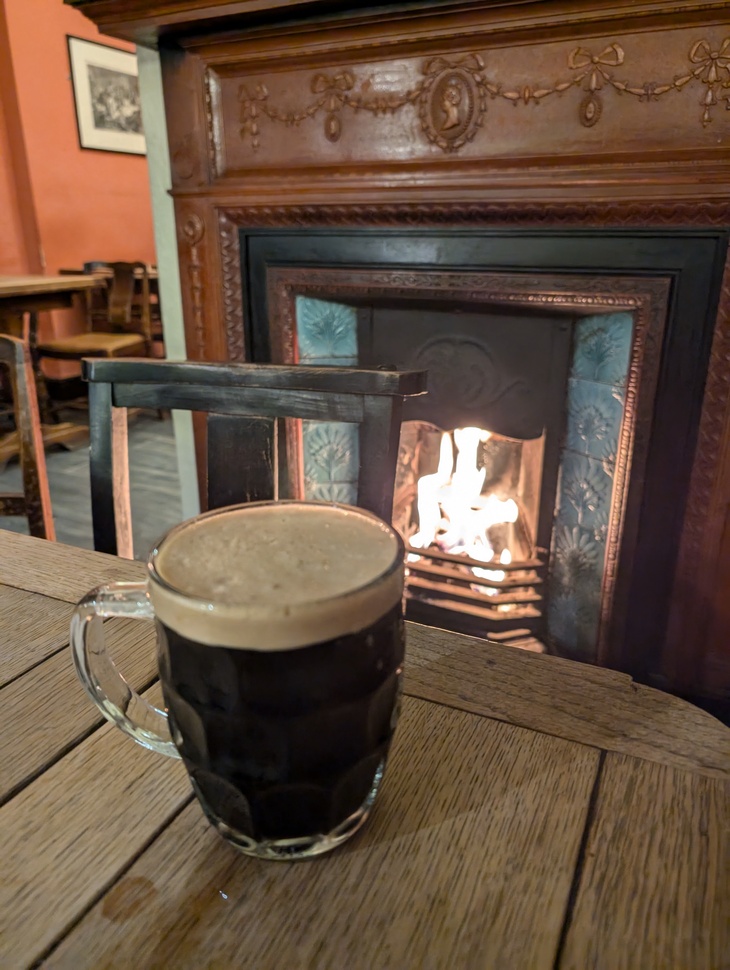 A pint in front of a fire