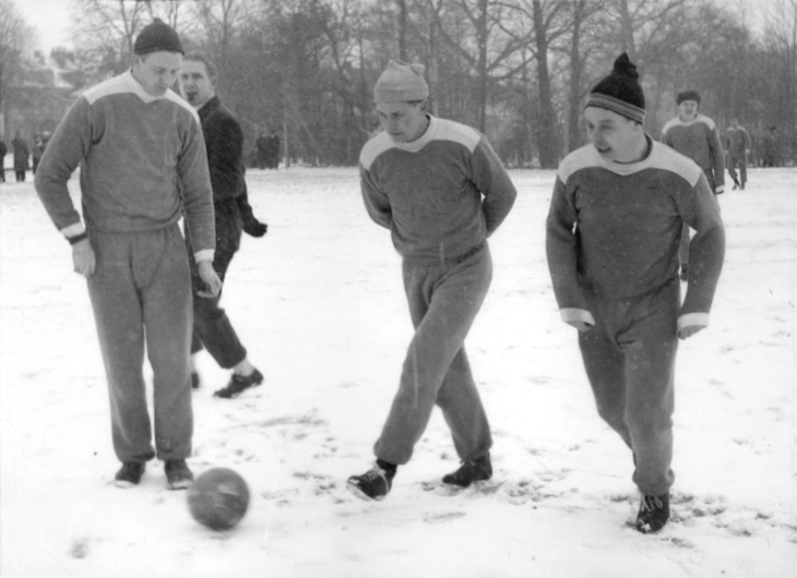 People playing football in the snow