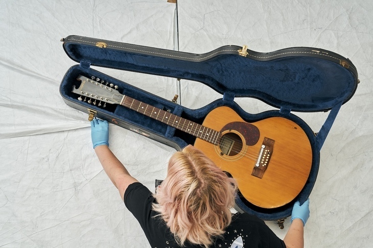 Free things to do in London: a curator examining David Bowie's guitar in its case