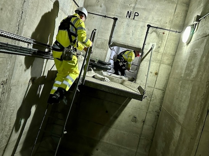 Inside London Bridge, some people in hig-vis-navigating the space