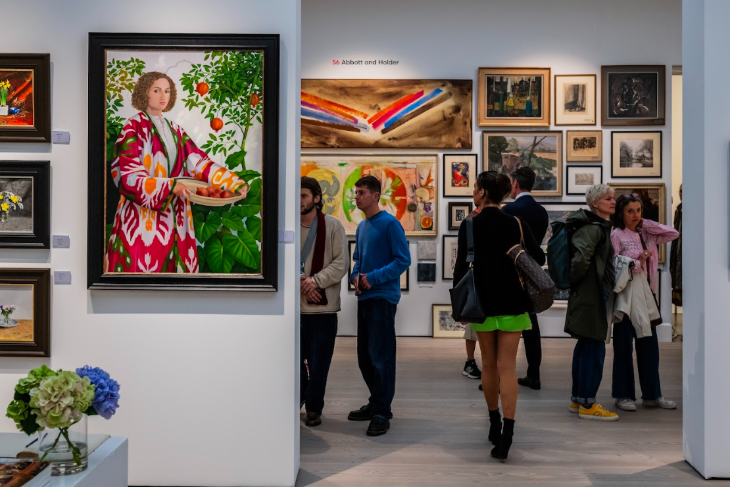 Things to do in London today: people viewing artworks on the walls of a gallery