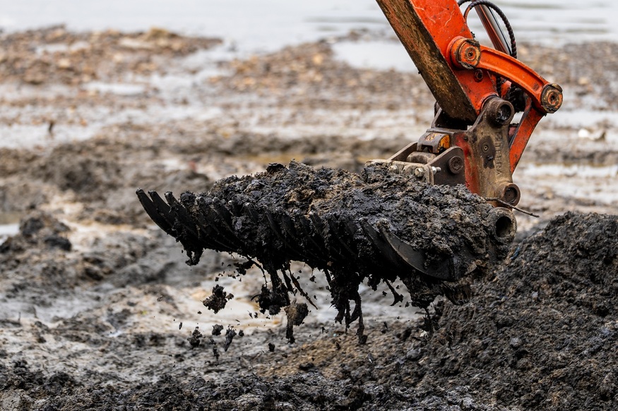 A digger scooping up congealed wet wipes