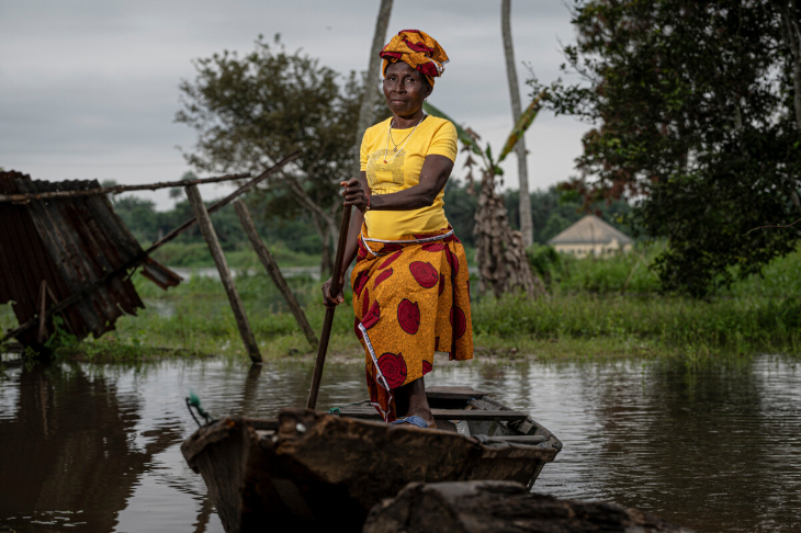 Things to do in London in October 2025: photograph of a woman standing in a wooden canoe, looking at the camera