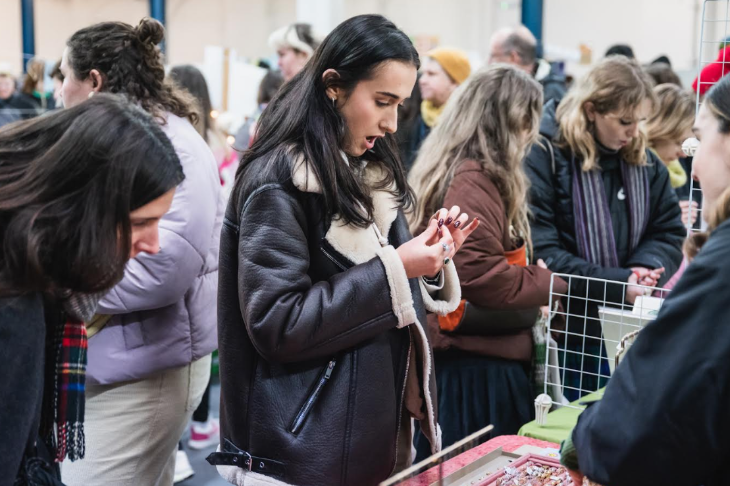 Things to do today in London: a woman browsing a jewellery stall