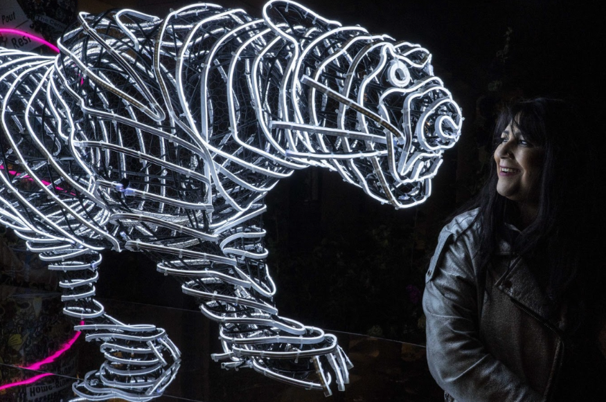 What's on today in London: a woman standing in front of a glowing white tiger sculpture