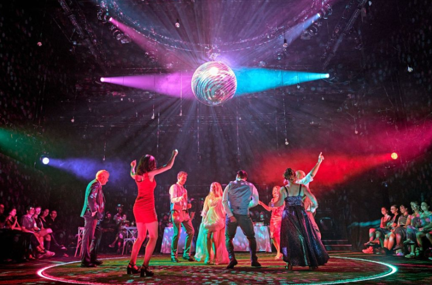 Things to do in London today: performers on stage dancing beneath a disco ball
