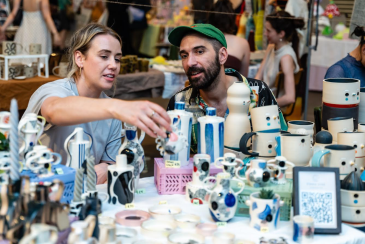 Things to do in London this weekend: a couple perusing a ceramics stall at a market