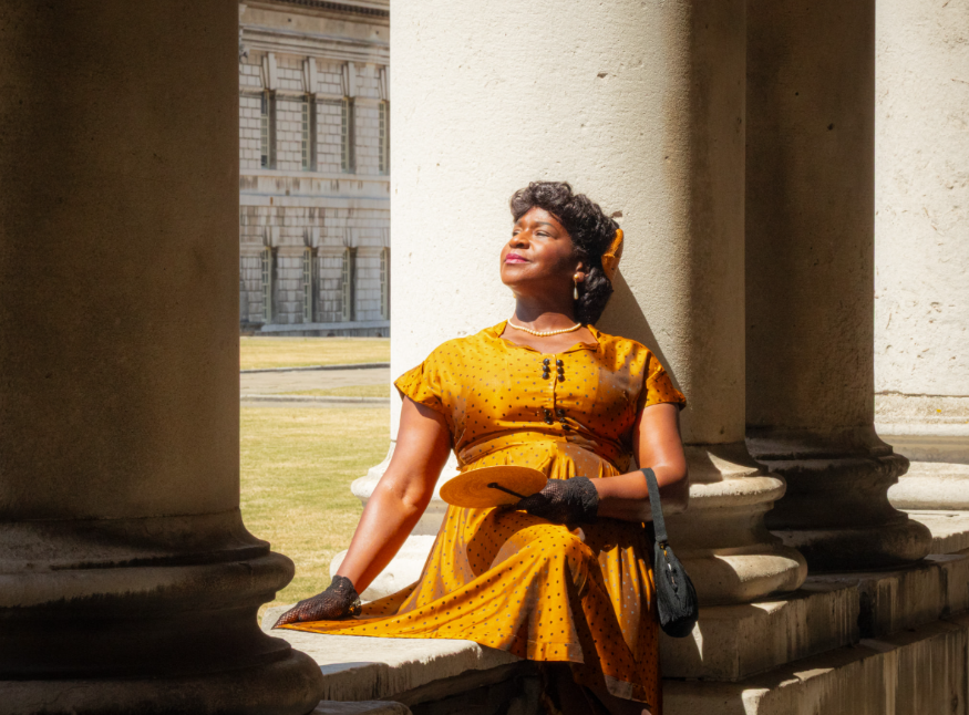 Things to do in London this weekend: a woman sitting among the pillars at the Old Royal Naval College