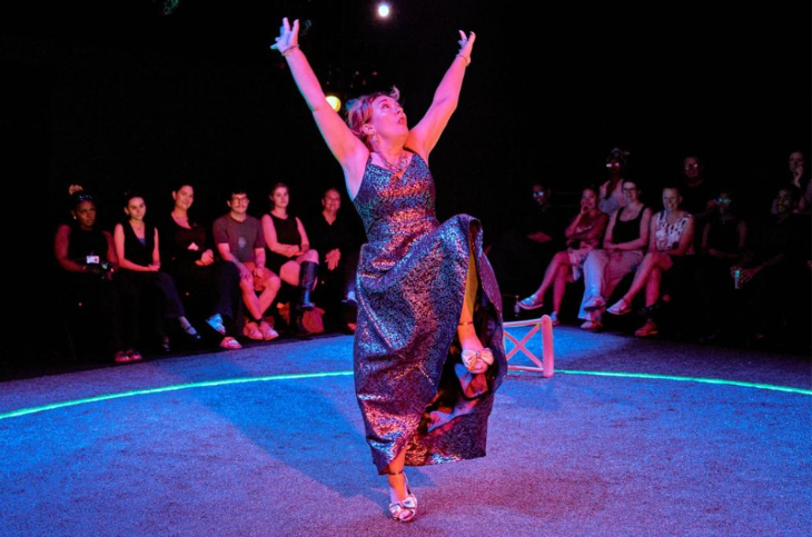 Things to do in London this weekend:  a woman alone on stage dancing with her hands in the air