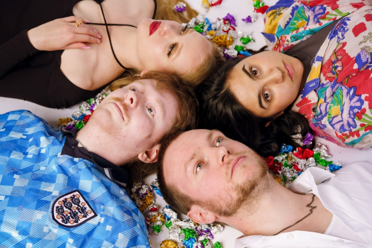 Things to do in London today: four people lying down on the ground on their backs with their heads together