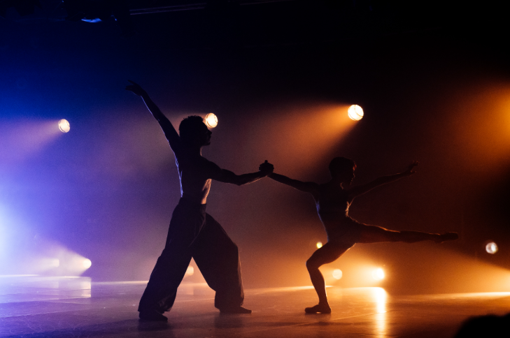 Things to do in London today: two dancers silhouetted in coloured lights on stage