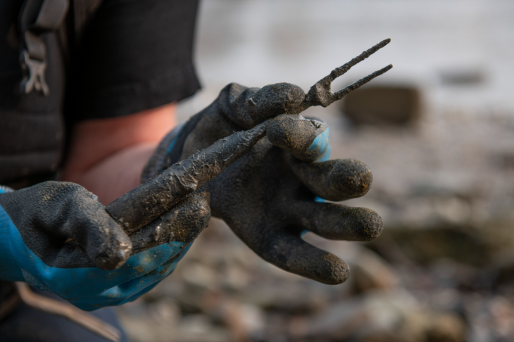 Things to do in London this weekend: a pair of gloved hands holding a muddy fork