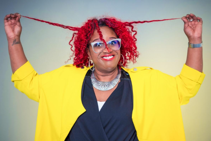 What's on today in London: Ninia Benjamin wearing a yellow cardigan and pulling strands of her red hair
