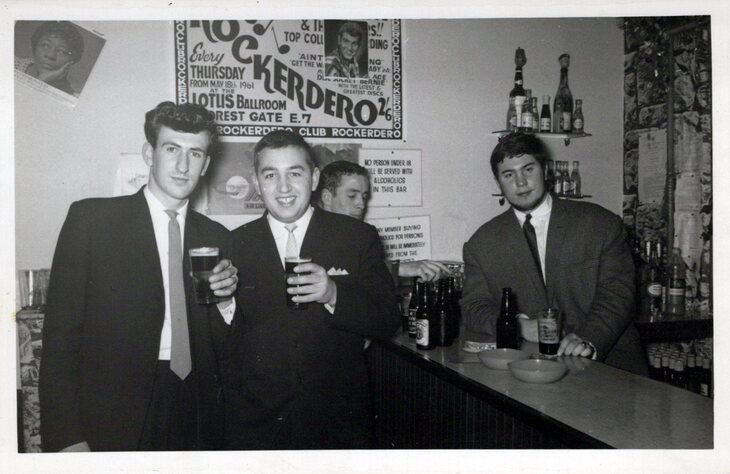 Kenny with other lads at the bar with a beer