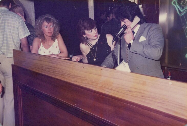 A DJ, apparently on the phone, 1980s.