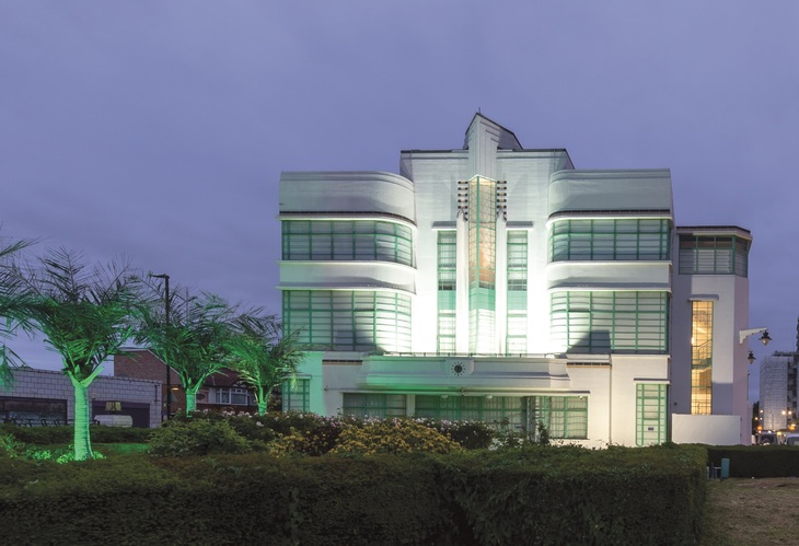 A gorgeous art deco building illuminated at night