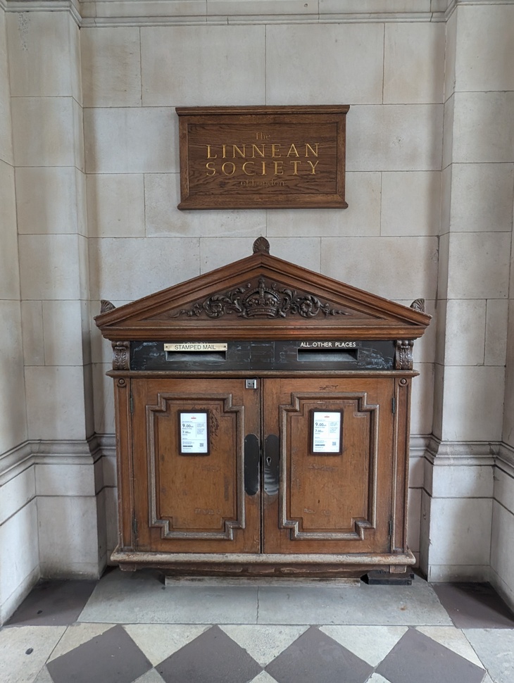 An ornate wooden post box
