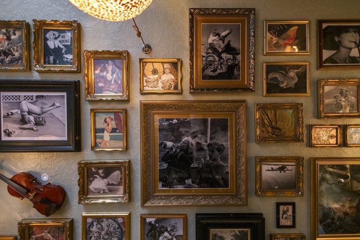 A range of paintings and photos on the wall