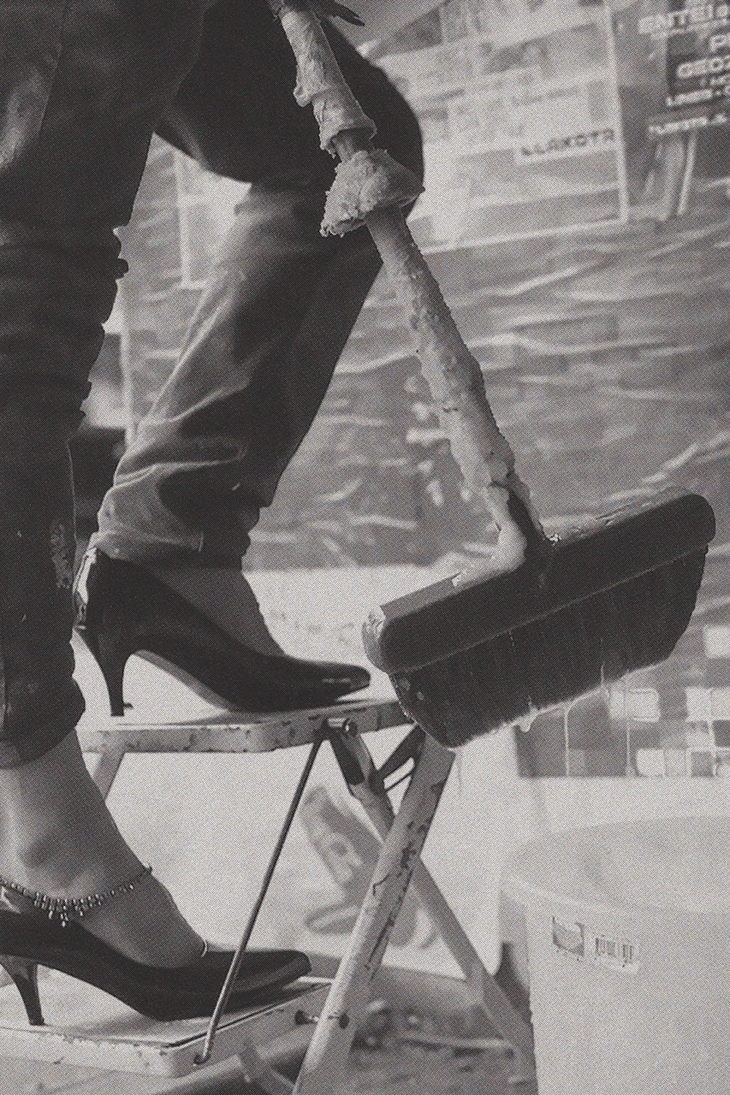 Feet of a fly-poster in high heels
