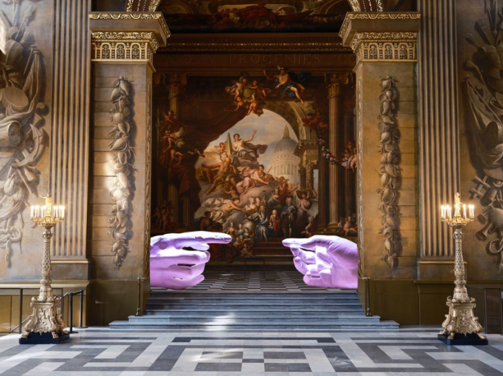 Things to do today in London: a giant pair of illuminated hands in a doorway of the Painted Hall