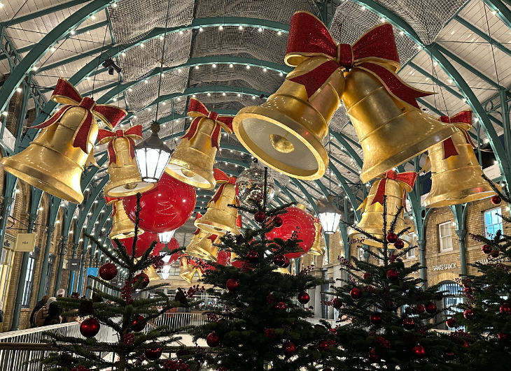 See London's Christmas 2025 decorations by bus: Giant bell decorations hanging overhead in Covent Garden Market