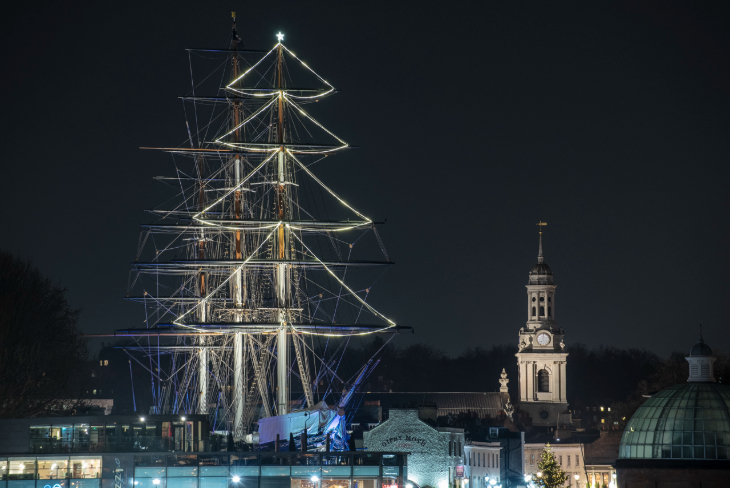 London Christmas lights 2025 switch-on dates: the rigging of the Cutty Sark illuminated in the shape of a Christmas tree against the night sky