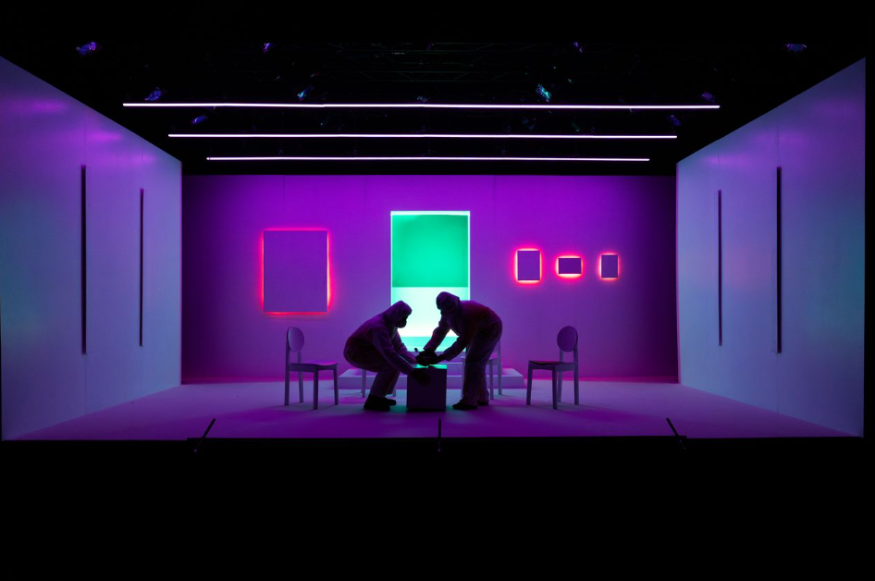 Today's events in London: two figures silhouetted around a coffee table on a purple-lit stage
