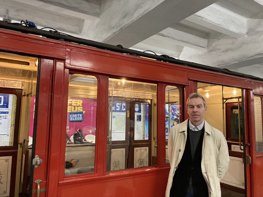 Andrew Martin in front of a vintage Tube train