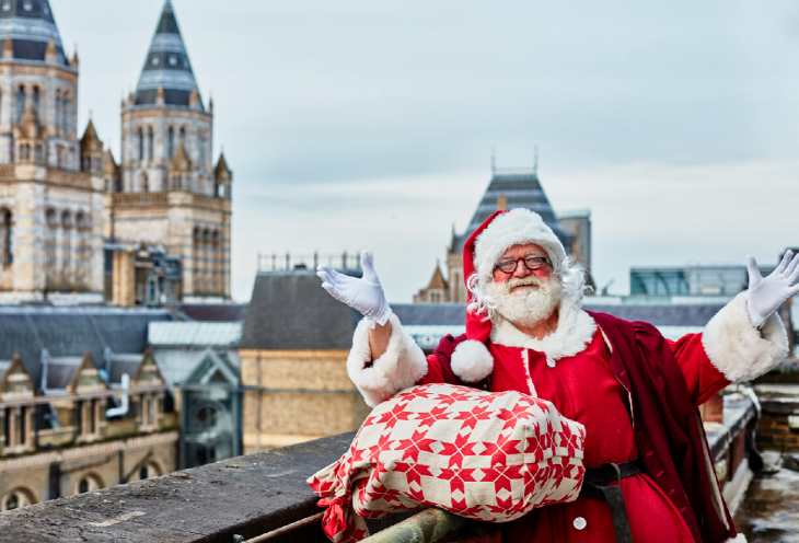 Best Santa's grottos meet Father Christmas London 2025 tickets: Santa with his sack of gifts on the roof of the Natural History Museum