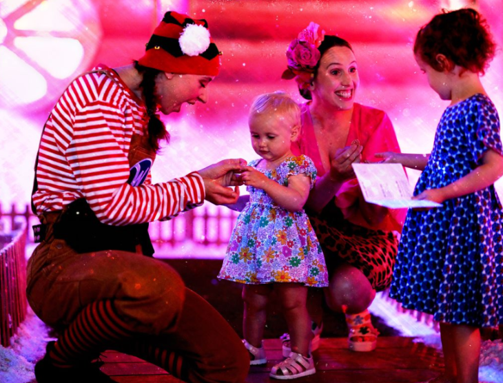 Best Santa's grottos meet Father Christmas London 2025 tickets: an elf interacting with a woman and two young children