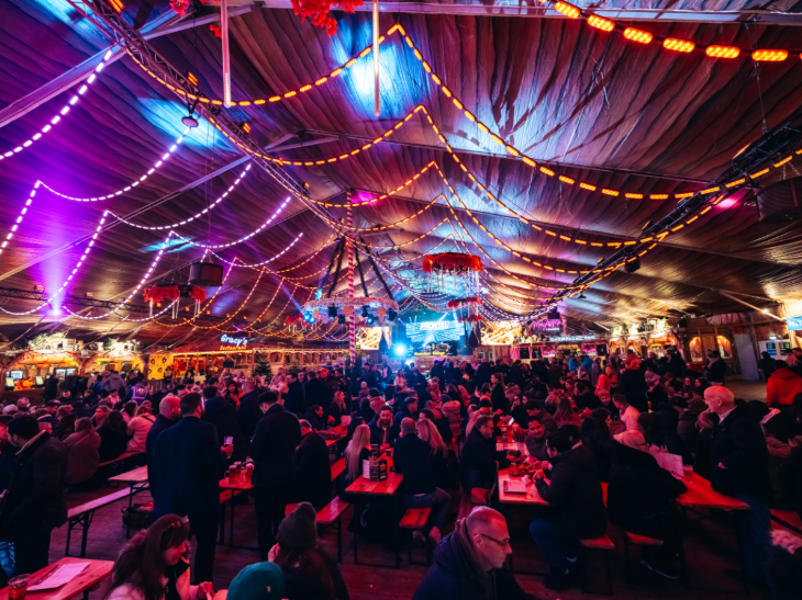 What's on in London in November 2025: people eating and drinking in a large marquee at Winter Wonderland