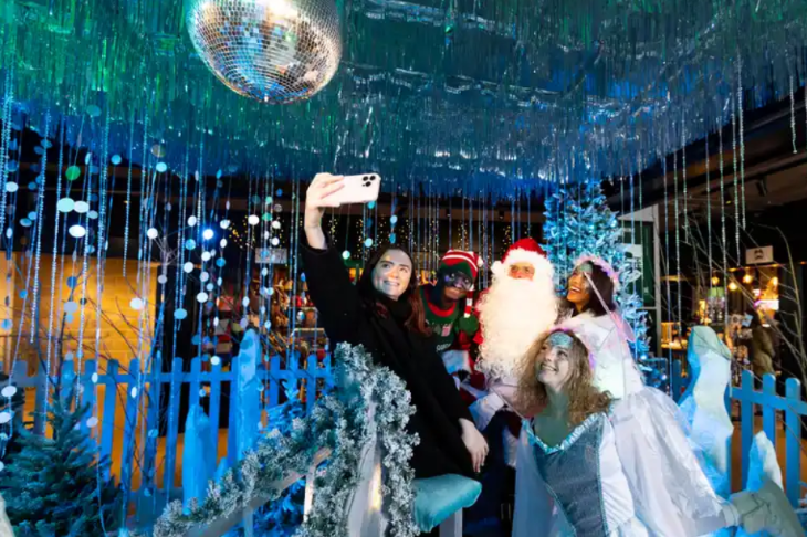 Best Santa's grottos meet Father Christmas London 2025 tickets: a failmy posing for a selfie in an ice grotto