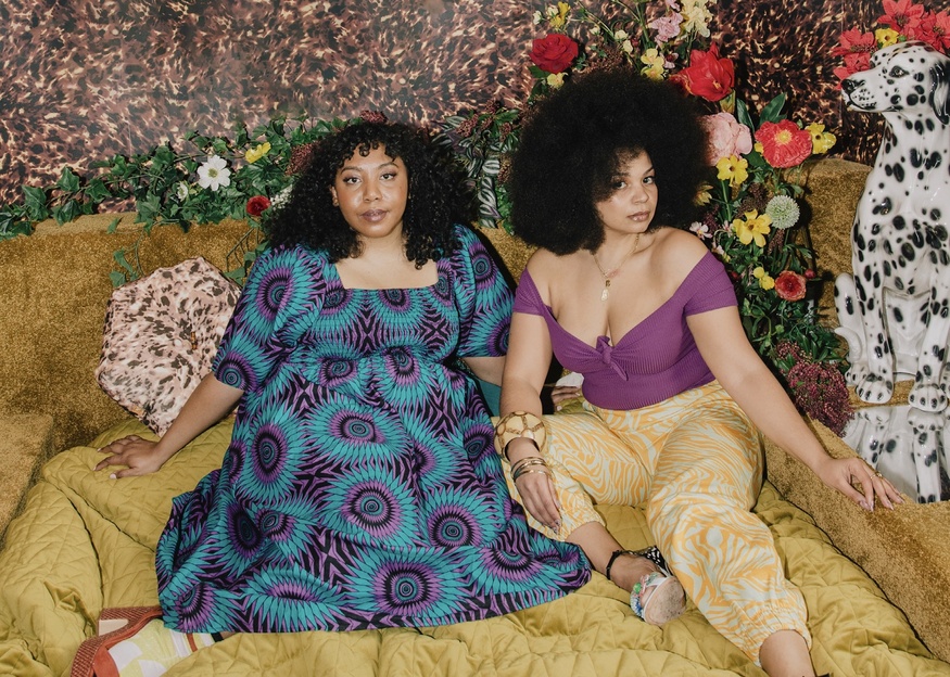 Emma Slade Edmondson & Nicole Ocran on a bed