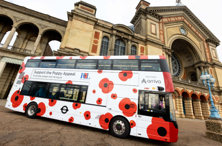 A bus decorated with poppies parked outside Alexandra Palace
