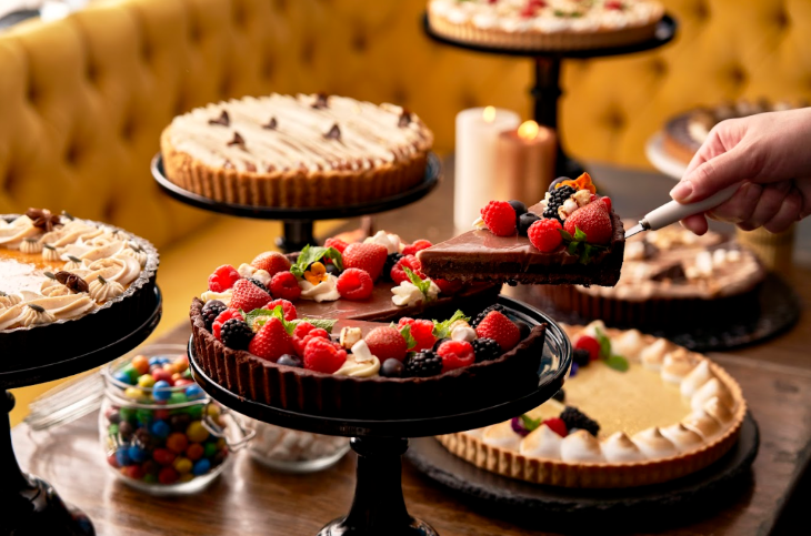 Thanksgiving 2025 in London: a table with various different sweet pies displayed on pie stands