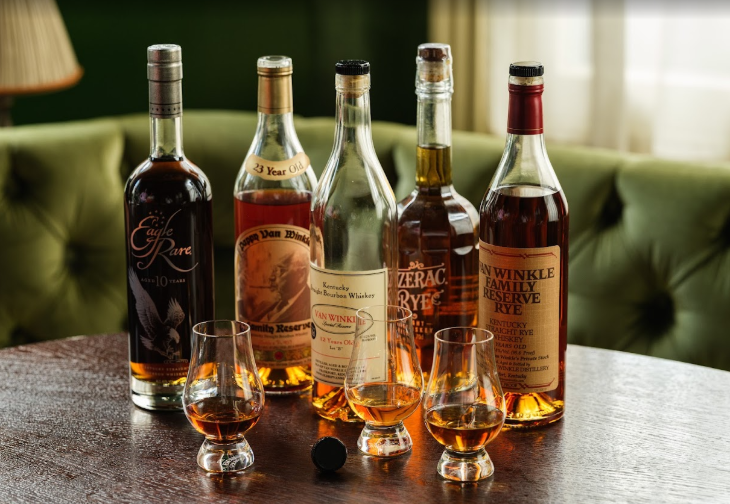 Thanksgiving 2025 in London: five bottles of whiskey and three glasses lined up on a pub table