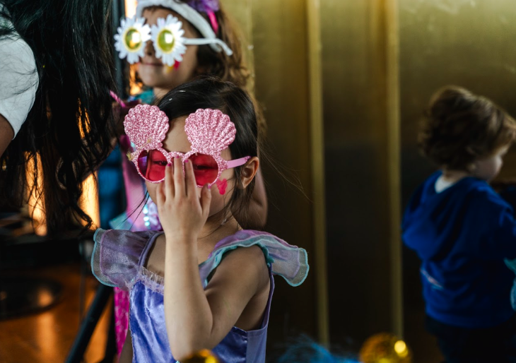 Things to do in London this weekend: a girl wearing a princess dress and seashell sunglasses