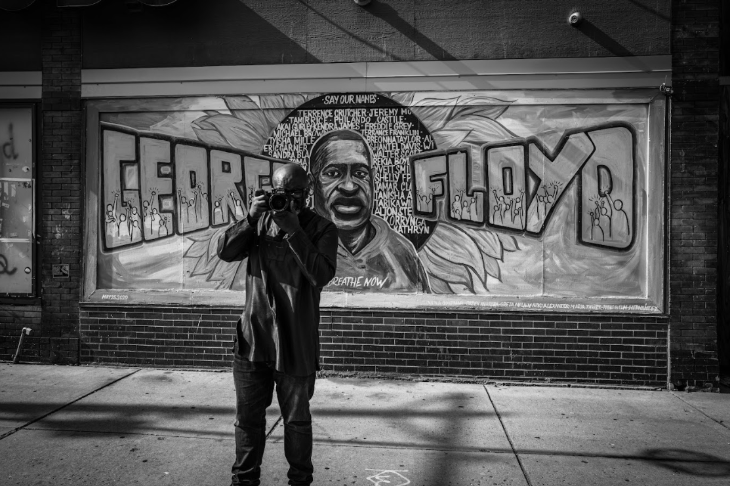 Today's events in London: a black and white photo of a photographer in front of a George Floyd mural
