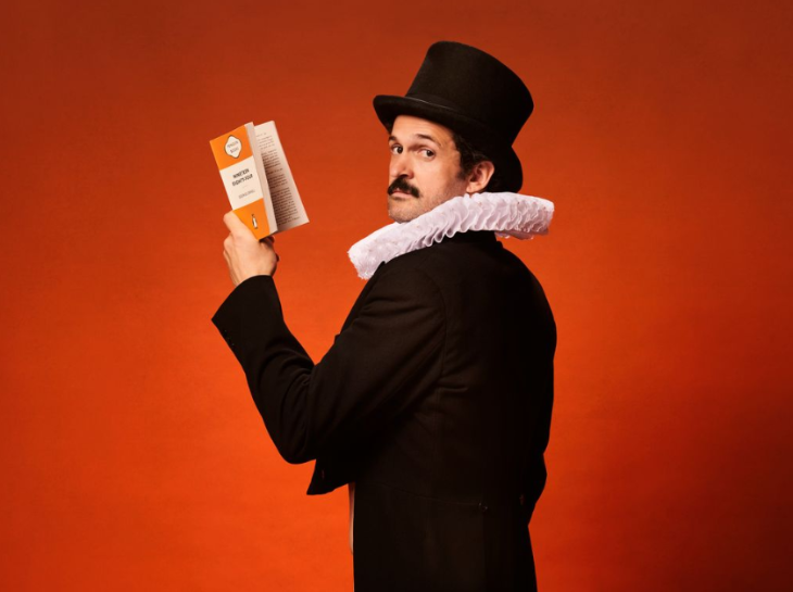 Things to do today in London: a man dressed in black jacket and hat and Elizabethan-style ruff, holding a Penguin Classics book