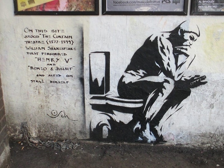 Street art showing a man on a toilet seat