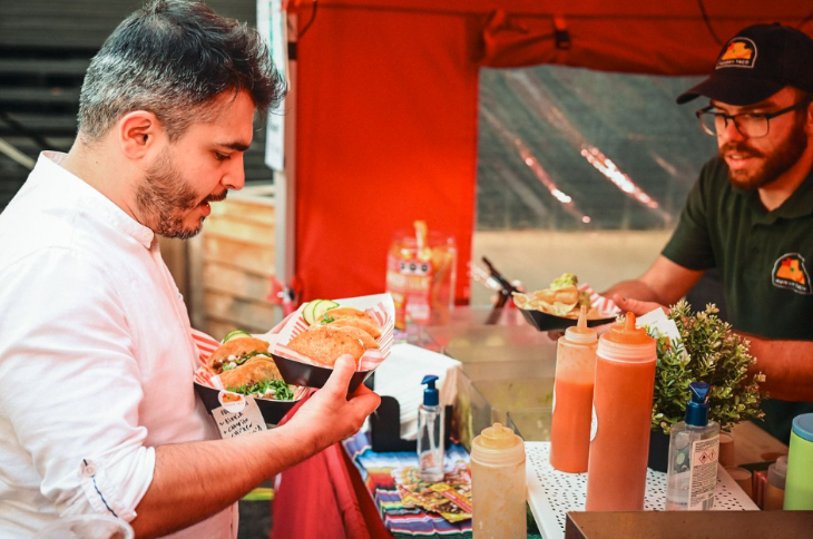 Things to do in London November 2025: a trader serving a man tacos at the London Taco Festival