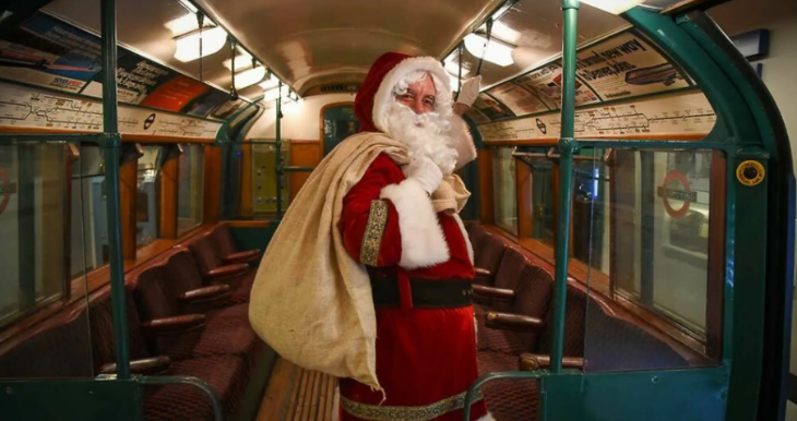 Best Santa's grottos meet Father Christmas London 2025 tickets: Santa standing on a vintage tube carriage with his sack sling over his shoulder