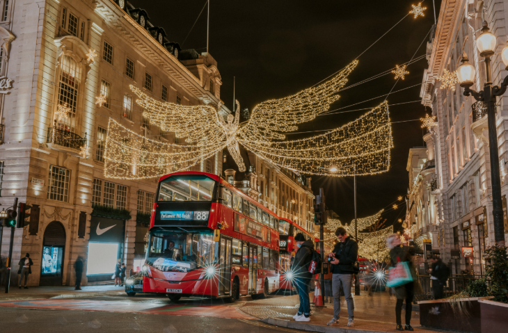 Best bus route to see London's Christmas lights: red double-decker buses driving beneath the Regent Street angels Christmas lights