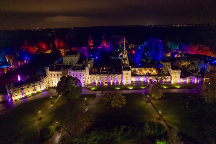 Winter light trails festivals near London Christmas 2025: an aerial view of a large manor house illuminated at night