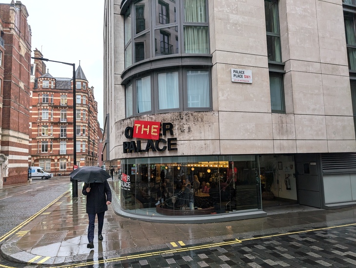 A person with an umbrella walking past the theatre