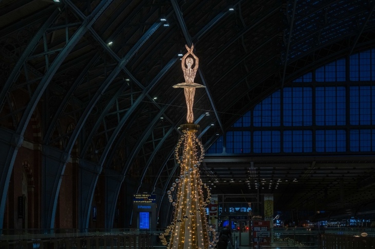 A glowing ballerina on top of the tree