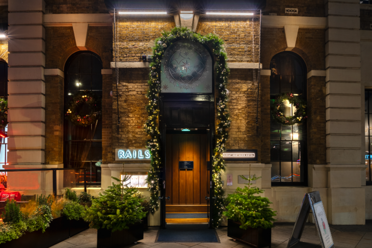 London restaurants on Christmas Day 2025: the entrance to RAILS restaurant decorated with a festive garland